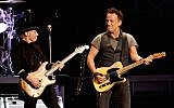 Musicians Nils Lofgren (L) and Bruce Springsteen and the E Street Band perform at the Los Angeles Sports Arena on March 15, 2016 in Los Angeles, California.  (Photo by Kevin Winter/Getty Images via JTA)