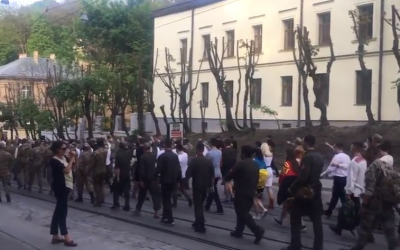 Far-right activists march in Lviv, Ukraine, wearing the uniform of the 14th Waffen Grenadier Division of the SS, an elite Nazi unite with many ethnic Ukrainians also known as the 1st Galician. April 28, 2018. (Screen capture; YouTube)
