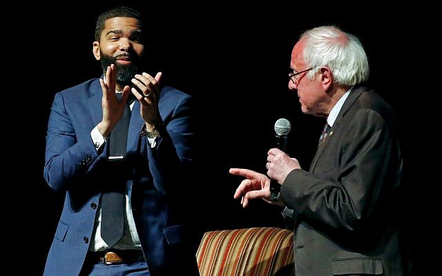 In this April 4, 2018 photo, Jackson Mayor Chokwe Antar Lumumba, left, applauds as US Sen. Bernie Sanders, I-Vt., answers a question during a town hall meeting examining economic justice 50 years after the assassination of Dr. Martin Luther King Jr., in Jackson, Miss. (AP Photo/Rogelio V. Solis) In this April 4, 2018 photo, Jackson Mayor Chokwe Antar Lumumba, left, applauds as US Sen. Bernie Sanders, I-Vt., answers a question during a town hall meeting examining economic justice 50 years after the assassination of Dr. Martin Luther King Jr., in Jackson, Miss. (AP Photo/Rogelio V. Solis)