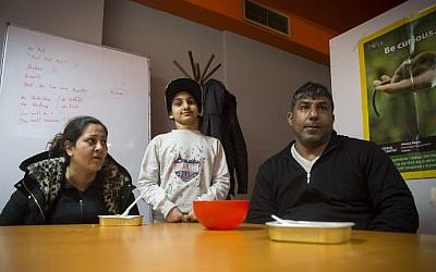 Ramin Lovimi, a refugee from Iran,  his wife Shahla Lovimi and their daughter Asma Lovimi are pictured during an interview with AFP at a migrant center in Belgrade on March 14, 2018. (AFP PHOTO / OLIVER BUNIC)