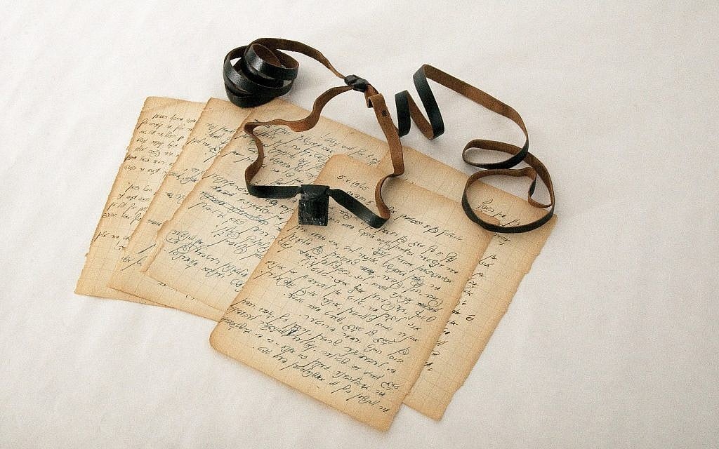 A set of tefillin and diary pages belonging to Isaac Avigdor, a young Polish rabbi imprisoned at Mauthausen, are on display at the Amud Aish Memorial Museum. Avigdor shared the smuggled tefillin with other inmates during his imprisonment. (Courtesy of Amud Aish/via JTA)