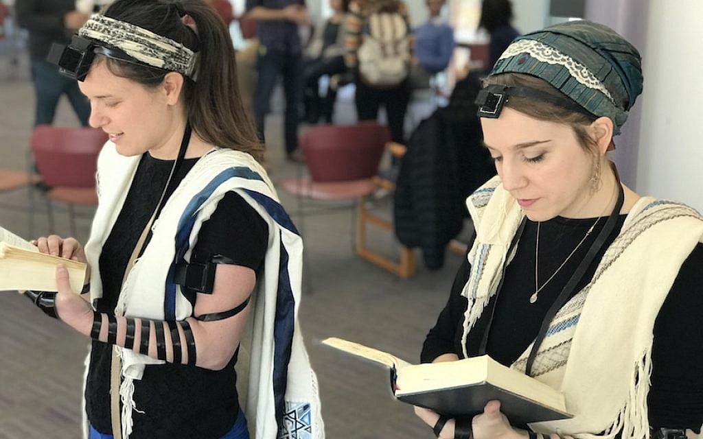 Illustrative: Rabbinical students at Hebrew College near Boston, including Gita Karasov, left, are creating a video that shows women, transgender and non-binary Jews demonstrating how to wear tefillin. (Dena Trugman/via JTA) Illustrative: Rabbinical students at Hebrew College near Boston, including Gita Karasov, left, are creating a video that shows women, transgender and non-binary Jews demonstrating how to wear tefillin. (Dena Trugman/via JTA)