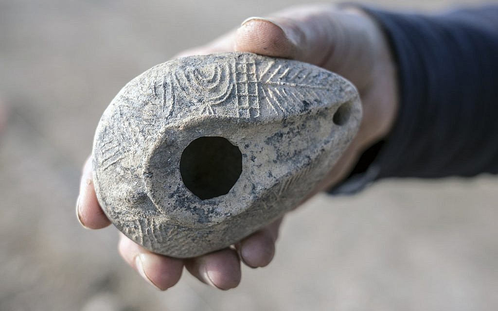 A lamp adorned with an eight-branched menorah which was exposed in the excavations while preparing the 70 km. Sanhedrin Trail in the Galilee. (Yaniv Berman, Israel Antiquities Authority)