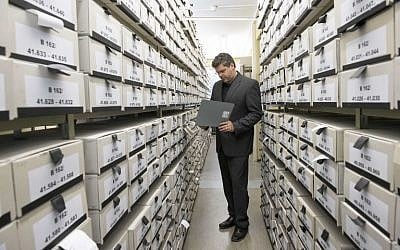 German prosecutor, head of Central Office of the Judicial Authorities of the Federal States for the Investigation of National Socialist Crimes, Jens Rommel stands in the archives room of the institution on April 19, 2018 in Ludwigsburg, southwestern Germany. (AFP PHOTO / THOMAS KIENZLE)