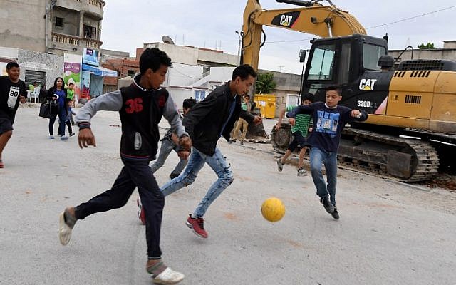 Children play football in the streets of Ettadhamen city on April 30, 2018, an impoverished area of Greater Tunis.
(AFP/ FETHI BELAID) Children play football in the streets of Ettadhamen city on April 30, 2018, an impoverished area of Greater Tunis.
(AFP/ FETHI BELAID)