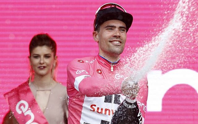 Dutch cyclist Tom Dumoilin of team Sunweb celebrates on the podium with the overall leader's pink jersey after winning the 1st stage of the 101st Giro d'Italia, on May 4, 2018, in Jerusalem. (AFP Photo/Luk Benies) Dutch cyclist Tom Dumoilin of team Sunweb celebrates on the podium with the overall leader's pink jersey after winning the 1st stage of the 101st Giro d'Italia, on May 4, 2018, in Jerusalem. (AFP Photo/Luk Benies)