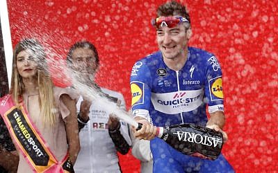 Italy's Elia Viviani celebrates on the podium after winning the 2nd stage of the 101st Giro d'Italia, Tour of Italy, on May 5, 2018, 167 kilometers between Haifa and Tel Aviv. (AFP PHOTO / LUK BENIES)