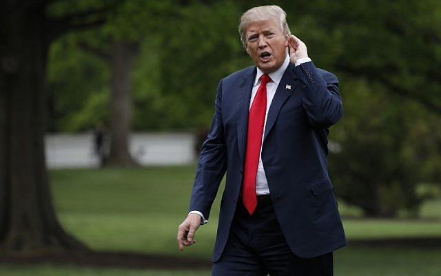 US President Donald Trump tries to listen to a question as walks on the South Lawn upon his return to the White House from Cleveland, Ohio, on May 5, 2018. (AFP Photo/Yuri Gripas) US President Donald Trump tries to listen to a question as walks on the South Lawn upon his return to the White House from Cleveland, Ohio, on May 5, 2018. (AFP Photo/Yuri Gripas)