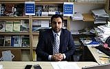 Human Rights Watch's Israel and Palestine director Omar Shakir, a US citizen, sits in his office in the West Bank city of Ramallah, May 9, 2018. (Abbas Momani/AFP)