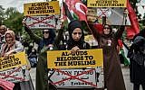 Women protestors hold placards reading "Al Quds belongs to muslims" on May 11, 2018 in Istanbul, during a demonstration against US President Donald Trump's decision to recognize Jerusalem as Israel's capital and move the US embassy to the city. 
(AFP PHOTO / OZAN KOSE)
