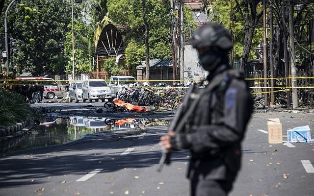 An Indonesian anti-terror policeman stands guard at the site of a suicide bomb attack outside a church in Surabaya on May 13, 2018. (AFP Photo/Juni Kriswanto) An Indonesian anti-terror policeman stands guard at the site of a suicide bomb attack outside a church in Surabaya on May 13, 2018. (AFP Photo/Juni Kriswanto)