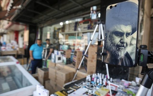 A picture taken on May 17, 2018 shows the face of Iraqi Shiite cleric and leader Muqtada al-Sadr adorning the plastic cover of a cell phone, on display at a peddlar's stall in a market street in the capital Baghdad. (AFP/AHMAD AL-RUBAYE) A picture taken on May 17, 2018 shows the face of Iraqi Shiite cleric and leader Muqtada al-Sadr adorning the plastic cover of a cell phone, on display at a peddlar's stall in a market street in the capital Baghdad. (AFP/AHMAD AL-RUBAYE)