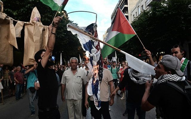 Palestinians who live in Thessaloniki burn USA and an Israeli flags in front of the US consulate during a demonstration on May 17, 2018, to denounce the bloodshed along the Gaza border and the relocation of the US embassy to Jerusalem. (AFP/Sakis MITROLIDIS) Palestinians who live in Thessaloniki burn USA and an Israeli flags in front of the US consulate during a demonstration on May 17, 2018, to denounce the bloodshed along the Gaza border and the relocation of the US embassy to Jerusalem. (AFP/Sakis MITROLIDIS)