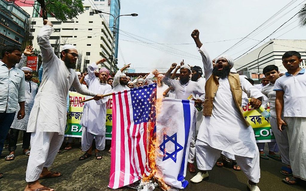 Activists from an Islamic organization burn the US and Israel flags during a protest after prayers on the first Friday of the holy month of Ramadan at a mosque in Dhaka on May 18, 2018. (AFP Photo/Munir Uz Zaman)