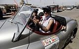 Drivers take part in the "Rallye des Graces" upon arriving in the Lebanese coastal city of Byblos, north of the capital Beirut, on May 19, 2018, during the first leg of the tour. / AFP PHOTO / JOSEPH EID