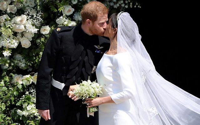 Britain's Prince Harry, Duke of Sussex kisses his wife Meghan, Duchess of Sussex as they leave from the West Door of St George's Chapel, Windsor Castle, in Windsor, on May 19, 2018 after their wedding ceremony. (AFP/ Andrew Matthews) Britain's Prince Harry, Duke of Sussex kisses his wife Meghan, Duchess of Sussex as they leave from the West Door of St George's Chapel, Windsor Castle, in Windsor, on May 19, 2018 after their wedding ceremony. (AFP/ Andrew Matthews)