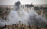 Smoke rises from buildings in a rebel-held neighborhood of Daraa in southern Syria following reported shelling by the Syrian regime on May 22, 2018. (AFP Photo/Mohamad Abazeed)