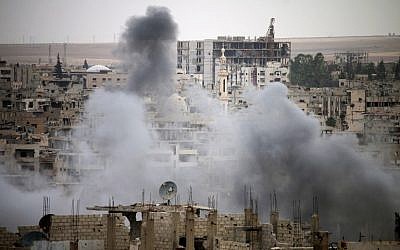 Smoke rises from buildings in a rebel-held neighborhood of Daraa in southern Syria following reported shelling by the Syrian regime on May 22, 2018. (AFP Photo/Mohamad Abazeed)