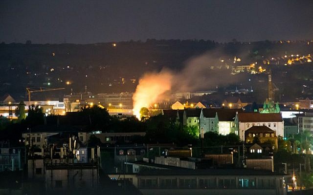 This picture taken during the night of May 23, 2018, shows a burning spot (C) on the site in Dresden, eastern Germany, where a World War II bomb was found and defused. (AFP PHOTO / dpa / Marco Klinger / Germany OUT) This picture taken during the night of May 23, 2018, shows a burning spot (C) on the site in Dresden, eastern Germany, where a World War II bomb was found and defused. (AFP PHOTO / dpa / Marco Klinger / Germany OUT)