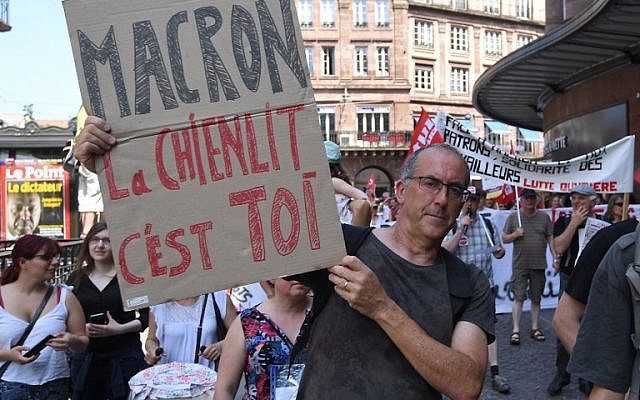 A man holds a placard reading "Macron the havoc it's you" during a "maree populaire" (working-class tide) demonstration called by political organisations, associations and unions to protest against the French President and government's policy, in Strasbourg on May 26, 2018. (AFP PHOTO / PATRICK HERTZOG) A man holds a placard reading "Macron the havoc it's you" during a "maree populaire" (working-class tide) demonstration called by political organisations, associations and unions to protest against the French President and government's policy, in Strasbourg on May 26, 2018. (AFP PHOTO / PATRICK HERTZOG)