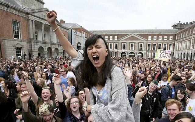 'Yes' campaigners celebrate the official result of the Irish abortion referendum at Dublin Castle in Dublin on May 26, 2018, which showed a landslide decision in favor of repealing the constitutional ban on abortions. (AFP Photo/Paul Faith)