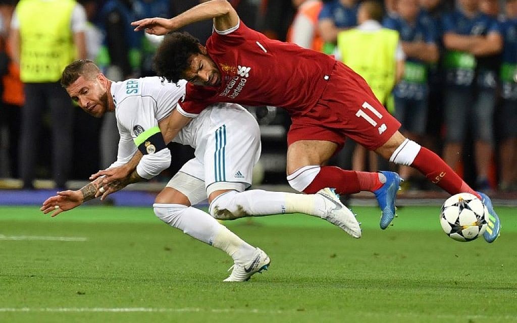 Liverpool's Egyptian forward Mohamed Salah (R) falls with Real Madrid's Spanish defender Sergio Ramos leading to Salah being injured during the UEFA Champions League final football match between Liverpool and Real Madrid at the Olympic Stadium in Kiev, Ukraine, on May 26, 2018. (AFP PHOTO/GENYA SAVILOV)