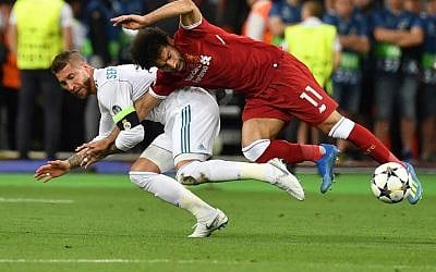 Liverpool's Egyptian forward Mohamed Salah (R) falls with Real Madrid's Spanish defender Sergio Ramos leading to Salah being injured during the UEFA Champions League final football match between Liverpool and Real Madrid at the Olympic Stadium in Kiev, Ukraine, on May 26, 2018. (AFP PHOTO/GENYA SAVILOV)