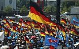 Alternative for Germany (AfD)'s demonstrators holding placards and German flags gather at the main station in Berlin to attend the "demonstration for the future of Germany" called by the far-right AfD in Berlin on May 27, 2018. (AFP PHOTO / Odd ANDERSEN)