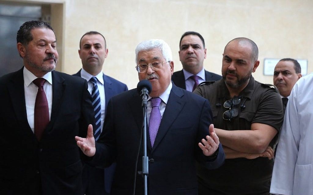 Palestinian Authority President Mahmoud Abbas, flanked by his two sons Yasser, left, and Tarek, right, gives a short statement before leaving a Ramallah hospital on May 28, 2018. (AFP Photo/Abbas Momani) Palestinian Authority President Mahmoud Abbas, flanked by his two sons Yasser, left, and Tarek, right, gives a short statement before leaving a Ramallah hospital on May 28, 2018. (AFP Photo/Abbas Momani)