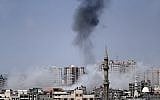 A picture taken from Gaza City on May 29, 2018, shows a smoke billowing in the background following an Israeli air strike on the Palestinian enclave. (AFP PHOTO / THOMAS COEX)