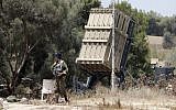 Israeli soldiers stand guard next to an Iron Dome defense system, designed to intercept and destroy incoming short-range rockets and artillery shells, deployed along the border with the Gaza Strip on May 29, 2018. (AFP Photo/Jack Guez)