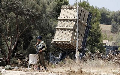 Israeli soldiers stand guard next to an Iron Dome defense system, designed to intercept and destroy incoming short-range rockets and artillery shells, deployed along the border with the Gaza Strip on May 29, 2018. (AFP Photo/Jack Guez)
