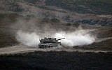 Illustrative: An Israeli army tank patrols along the border between Israel and the Gaza Strip on May 29, 2018. (Jack GUEZ/AFP)