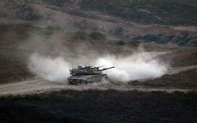 Illustrative: An Israeli army tank patrols along the border between Israel and the Gaza Strip on May 29, 2018. (Jack GUEZ/AFP)