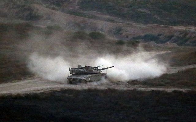 Illustrative: An Israeli army tank patrols along the border between Israel and the Gaza Strip on May 29, 2018. (Jack GUEZ/AFP) Illustrative: An Israeli army tank patrols along the border between Israel and the Gaza Strip on May 29, 2018. (Jack GUEZ/AFP)