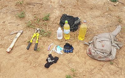 An axe, lighter fluid, gloves, wirecutters and a lighter, which were in the possession of three Palestinian men who were shot dead as they entered Israeli territory from the Gaza Strip on May 6, 2018. (Israel Defense Forces)