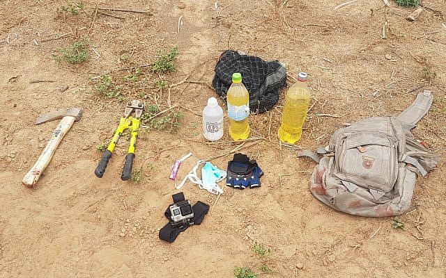 An axe, lighter fluid, gloves, wirecutters and a lighter, which were in the possession of three Palestinian men who were shot dead as they entered Israeli territory from the Gaza Strip on May 6, 2018. (Israel Defense Forces) An axe, lighter fluid, gloves, wirecutters and a lighter, which were in the possession of three Palestinian men who were shot dead as they entered Israeli territory from the Gaza Strip on May 6, 2018. (Israel Defense Forces)