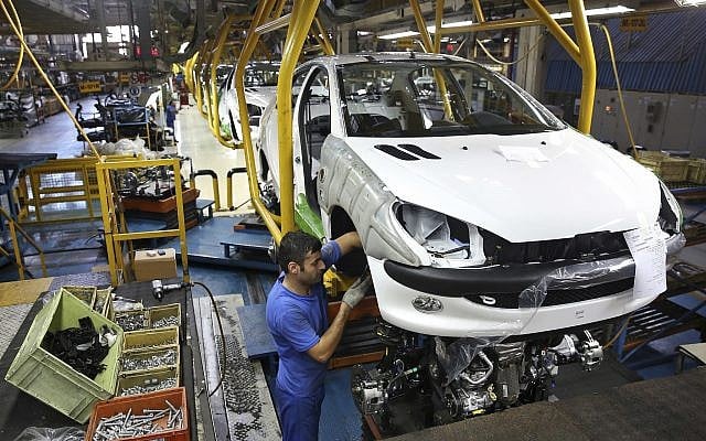An Iranian worker assembles a Peugeot 206 at the state-run Iran-Khodro automobile manufacturing plant near Tehran, Iran, 11, 2014. (AP Photo/Ebrahim Noroozi, File) An Iranian worker assembles a Peugeot 206 at the state-run Iran-Khodro automobile manufacturing plant near Tehran, Iran, 11, 2014. (AP Photo/Ebrahim Noroozi, File)