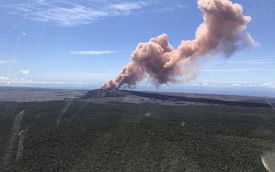 In this photo provided by the US Geological Survey, red ash rises from the Puu Oo vent on Hawaii's Kilauea Volcano after a magnitude-5.0 earthquake struck the Big Island, Thursday, May 3, 2018 in Hawaii Volcanoes National Park. (Kevan Kamibayashi/US Geological Survey via AP)