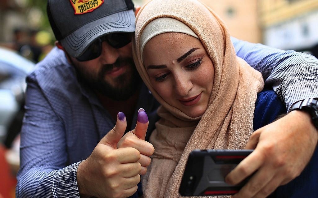 A couple take a selfie as they display their ink-stained fingers after casting their votes during Lebanon's parliamentary elections in Beirut, Lebanon, Sunday, May 6, 2018 (AP Photo/Hassan Ammar)