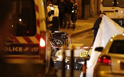 A dead body under a blanket after a knife attack that left at least two dead including the assailant in central Paris, early Sunday May 13, 2018. (AP Photo/Thibault Camus)