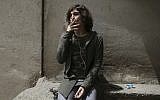 In this Sunday, April 22, 2018 photo, Nahal, a 19-year-old transgender woman, smokes a cigarette on her balcony in Tehran, Iran. (AP Photo/Vahid Salemi)
