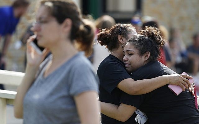 Santa Fe High School junior Guadalupe Sanchez, 16, cries in the arms of her mother, Elida Sanchez, after reuniting with her at a meeting point at a nearby Alamo Gym fitness center following a shooting at Santa Fe High School in Santa Fe, Texas, on Friday, May 18, 2018. (Michael Ciaglo/Houston Chronicle via AP) Santa Fe High School junior Guadalupe Sanchez, 16, cries in the arms of her mother, Elida Sanchez, after reuniting with her at a meeting point at a nearby Alamo Gym fitness center following a shooting at Santa Fe High School in Santa Fe, Texas, on Friday, May 18, 2018. (Michael Ciaglo/Houston Chronicle via AP)