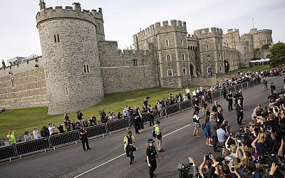 Crowds outside Windsor, near London, England, Friday, May 18, 2018. Preparations continue in Windsor ahead of the royal wedding of Britain's Prince Harry and Meghan Markle on Saturday May 19. (AP Photo/Emilio Morenatti)