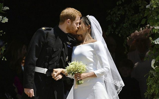 Britain's Prince Harry, Duke of Sussex kisses his wife Meghan, Duchess of Sussex as they leave from the West Door of St George's Chapel, Windsor Castle, in Windsor, on May 19, 2018 after their wedding ceremony. (Ben Birchhall, Pool/via AP) Britain's Prince Harry, Duke of Sussex kisses his wife Meghan, Duchess of Sussex as they leave from the West Door of St George's Chapel, Windsor Castle, in Windsor, on May 19, 2018 after their wedding ceremony. (Ben Birchhall, Pool/via AP)