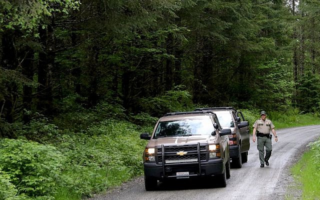 Washington State Fish and Wildlife Police leave the scene on a remote King County road near the site of a fatal cougar attack in East King County, Washington, May 19, 2018. (Alan Berner/The Seattle Times via AP) Washington State Fish and Wildlife Police leave the scene on a remote King County road near the site of a fatal cougar attack in East King County, Washington, May 19, 2018. (Alan Berner/The Seattle Times via AP)