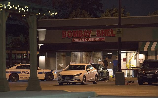 Police stand outside the Bombay Bhel restaurant in Mississauga, Canada Friday, May 25, 2018 (Doug Ives/The Canadian Press via AP) Police stand outside the Bombay Bhel restaurant in Mississauga, Canada Friday, May 25, 2018 (Doug Ives/The Canadian Press via AP)