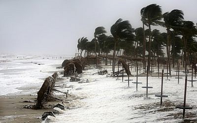 Debris and sea foam litter a beach after Cyclone Mekunu in Salalah, Oman, Saturday, May 26, 2018. (AP Photo/Kamran Jebreili)