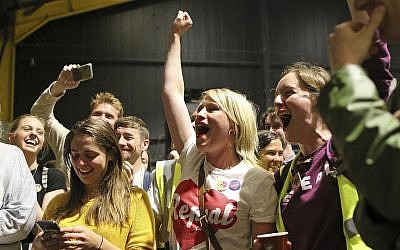 People from the "Yes" campaign react, as the results of the votes begin to come in the Irish referendum on the 8th Amendment of the Irish Constitution at the RDS count centre, in Dublin, Ireland, Saturday May 26, 2018. Ireland appeared to move away from its conservative Roman Catholic roots and embrace a more liberal view Friday as two major exit polls predicted voters had repealed a constitutional ban on abortion. (AP Photo/Peter Morrison)