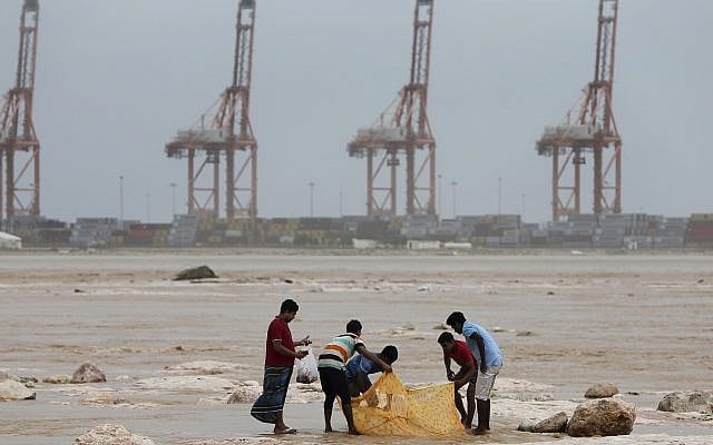 Asian workers fish in floodwaters after Cyclone Merkunu in Salalah, Oman, Saturday, May 26, 2018. (AP Photo/Kamran Jebreili) Asian workers fish in floodwaters after Cyclone Merkunu in Salalah, Oman, Saturday, May 26, 2018. (AP Photo/Kamran Jebreili)